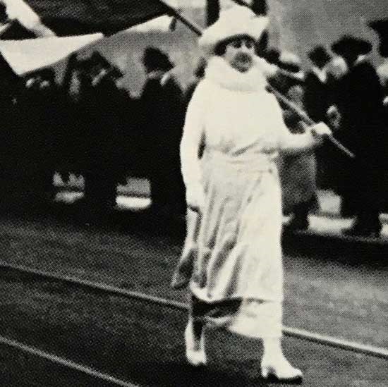 Adeline Levy Spear marching with flag in Suffrage Parade.