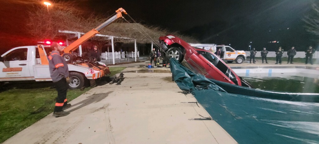car being towed from inside the pool
