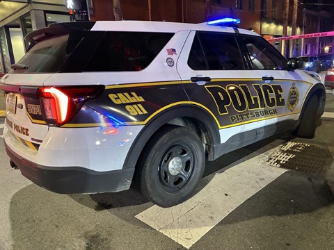 photo showing Pittsburgh police vehicle and red crime tape