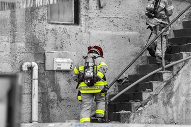Firefighters climb stairs.