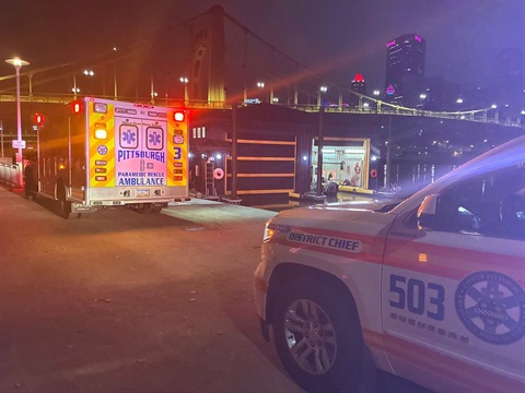 Shows River Rescue boat house and two ambulances