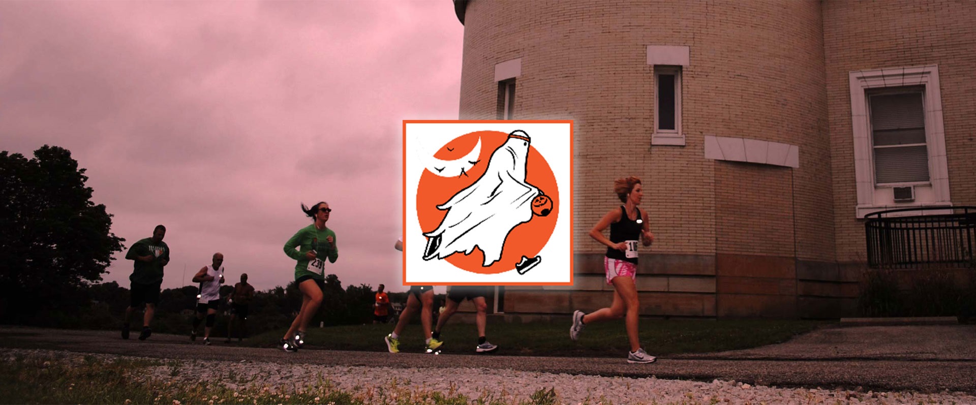 Riverview Park 5K background image of past runners near observatory with Halloween themed logo in foreground.