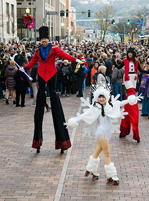 2025 Tree Lighting - Street performers on stilts and roller skates.